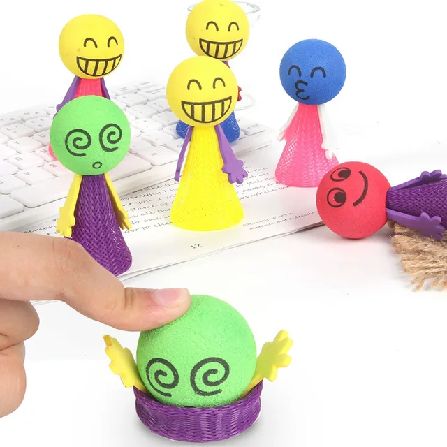 Colourful wooden pop-up jumping toy with smiling peg figures that spring up when pressed, designed for toddler cause and effect play