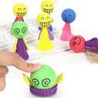 Colourful wooden pop-up jumping toy with smiling peg figures that spring up when pressed, designed for toddler cause and effect play