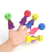 Colorful finger puppets on a person's fingers against a white background