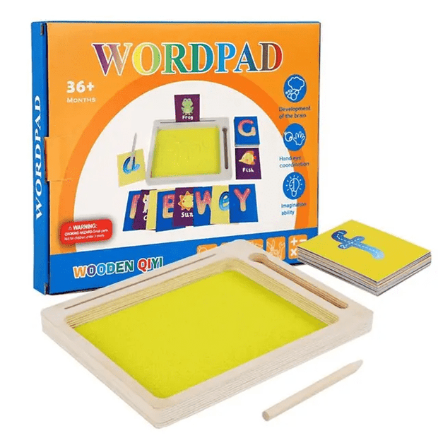 Wooden sand writing tray with bright yellow kinetic sand surface, wooden stylus and a set of illustrated alphabet and picture flashcards, shown alongside its colourful orange