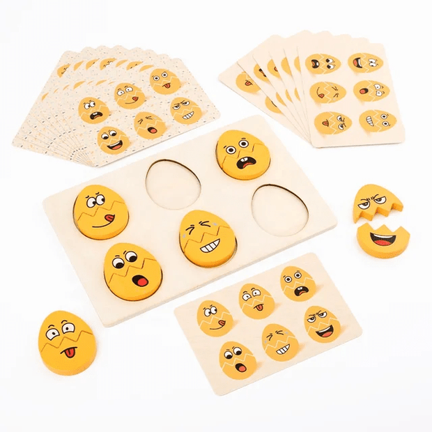 Wooden emoji egg face matching puzzle game showing a three-slot puzzle board, split emoji egg pieces with different expressions