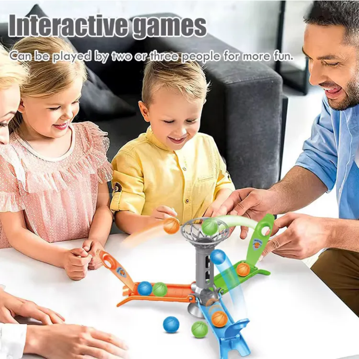 Family playing with a ball-throwing toy at a table