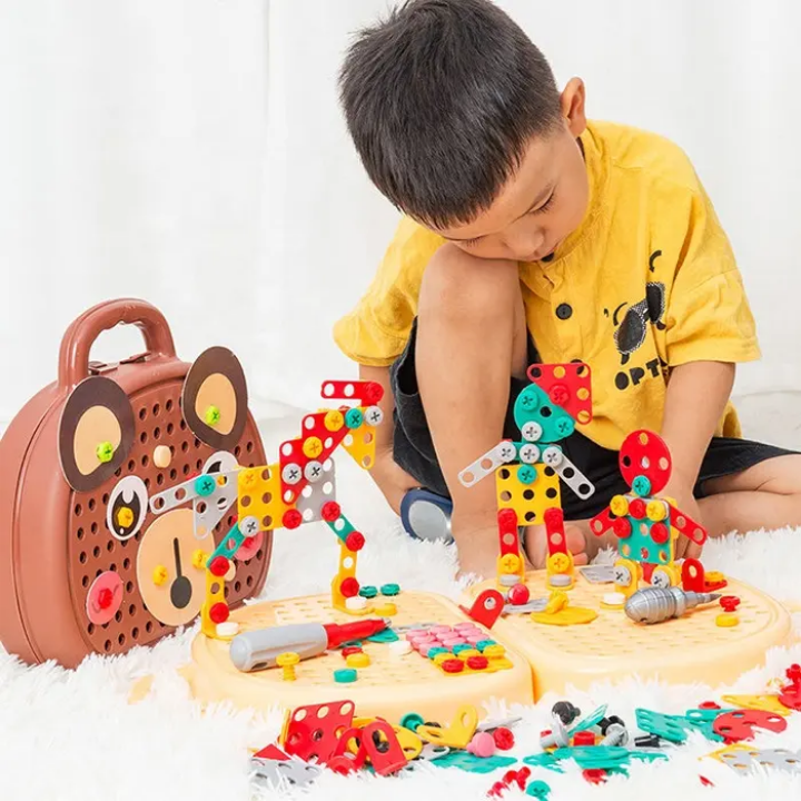 Child playing with a colorful building block set on a white surface