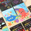 Collection of colorful scratch art cards with various designs including an octopus and a submarine.