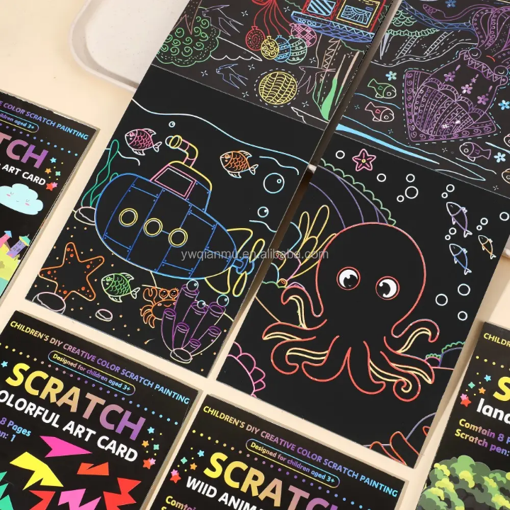 Scratch art cards with colorful designs on a wooden surface