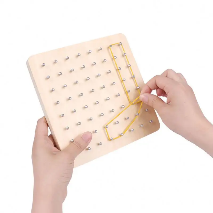 Wooden pegboard with beads and a yellow string, held by hands on a white background