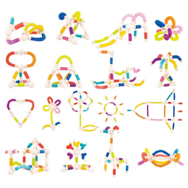 Set of colorful plastic building blocks in various shapes on a white background