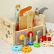 Wooden toy toolbox with tools and gears on a textured surface
