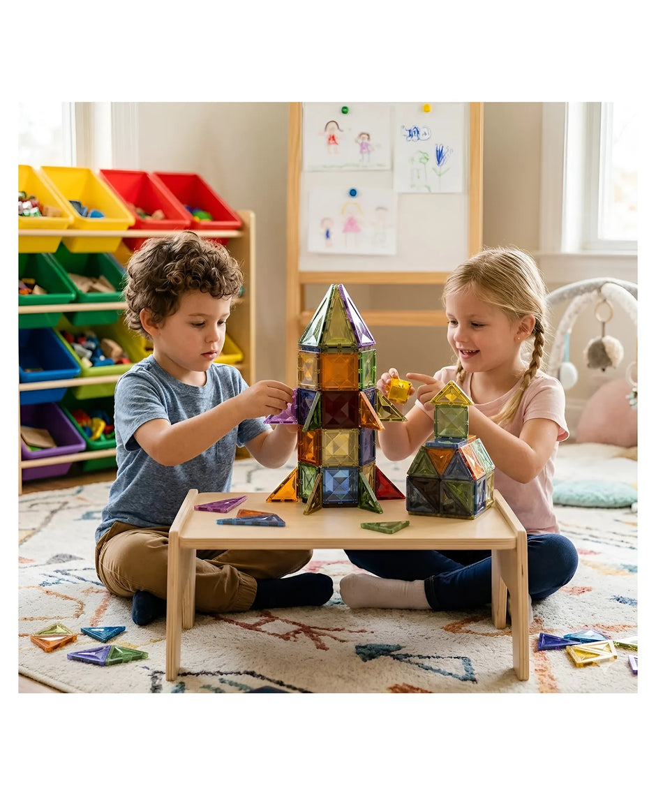 Two children playing with colorful building blocks in a classroom setting.