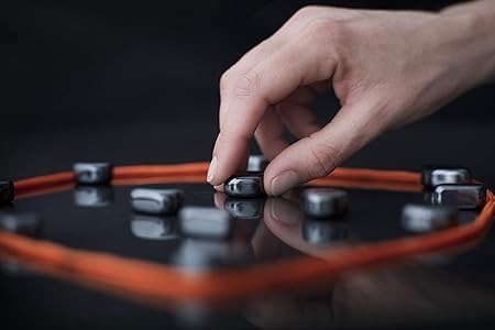 Hand interacting with electronic components on a dark surface