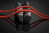 Red jump rope with black magnets on a reflective dark surface