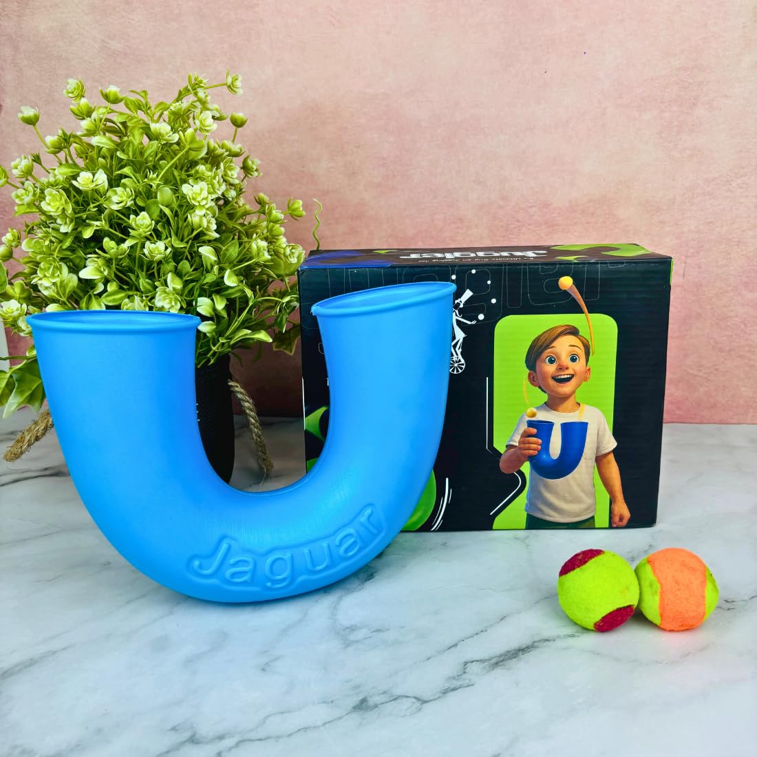 Green U-shaped juggler skill toy for kids with two balls for toss and catch active play, builds hand-eye coordination