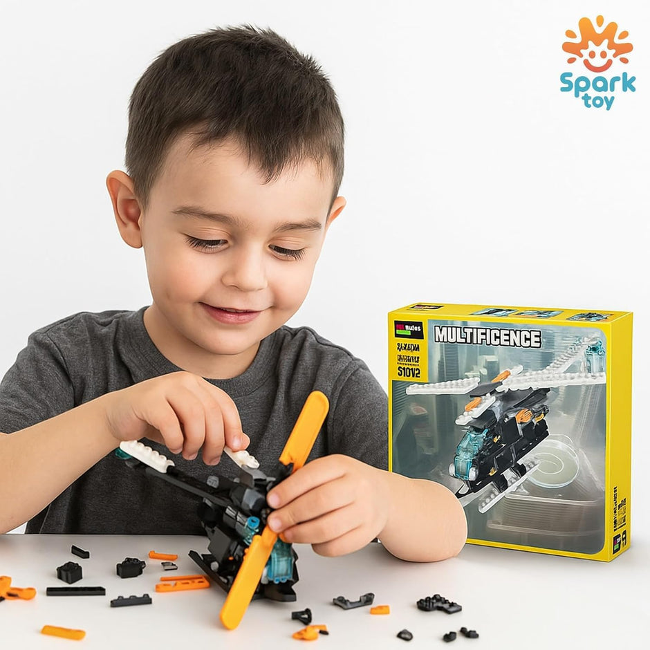 Child playing with building blocks in front of a toy packaging labeled 'Multificence' with Spark Toy logo.