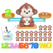 Educational toy set with monkey balance scale, number magnets, and additional monkey figures on a white background.