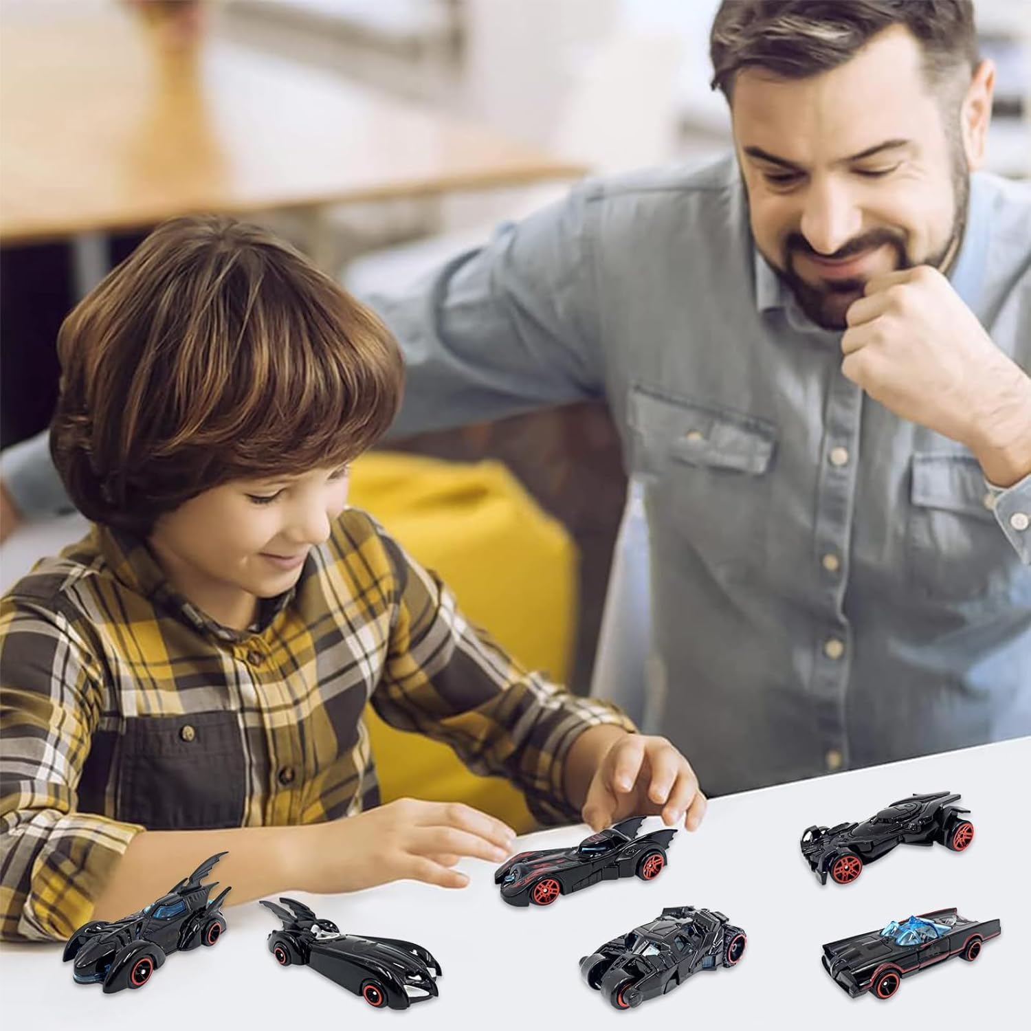 Man and child playing with toy cars on a table