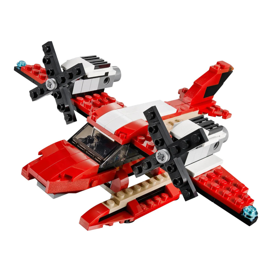 Red and black toy helicopter made of interlocking bricks on a white background