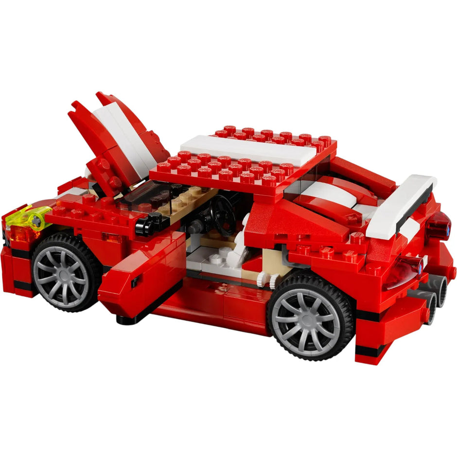 Red toy car made of interlocking bricks on a white background